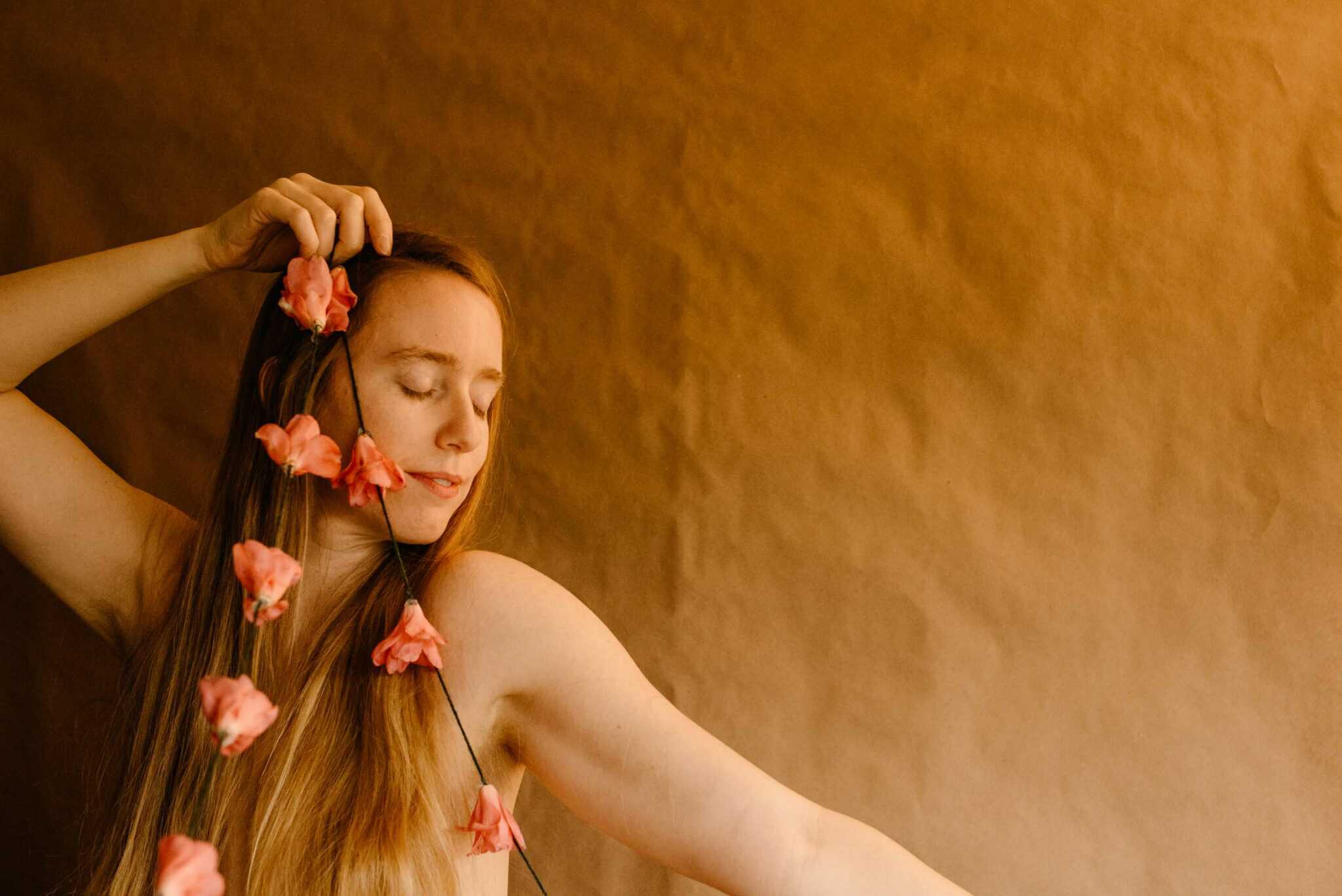 woman holding a camellia on a string in her hands