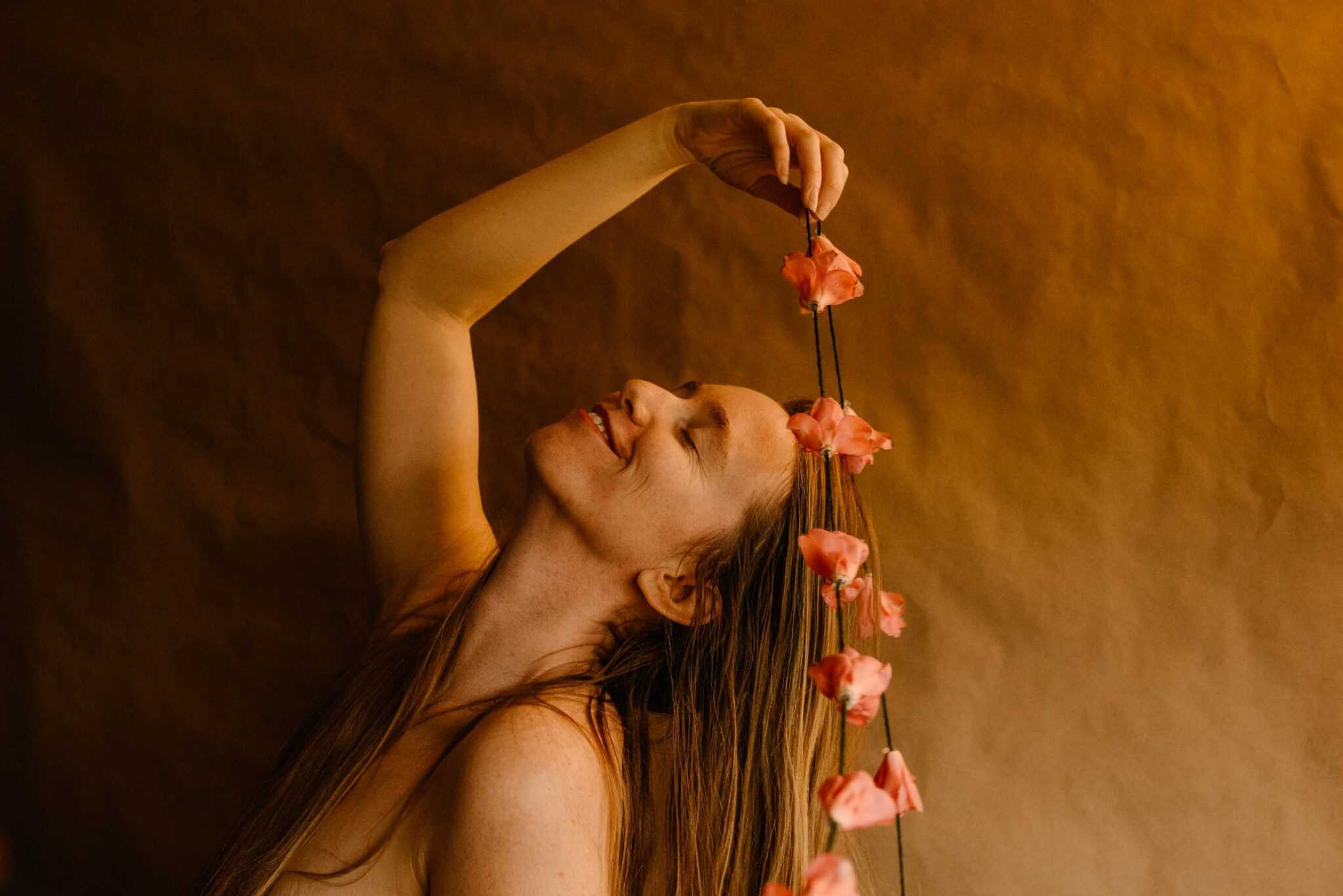 woman holding a camellia on a string in her hands