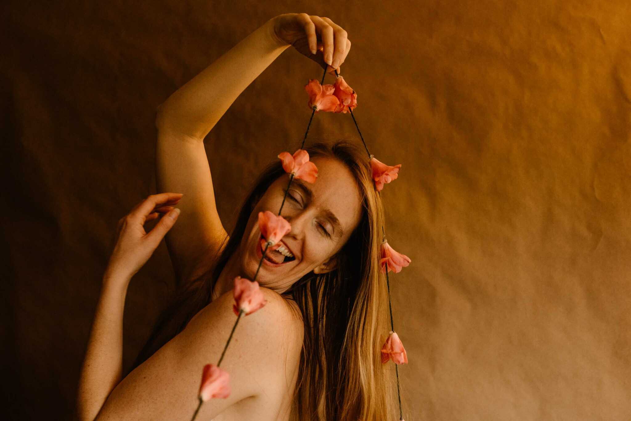 woman holding a camellia on a string in her hands