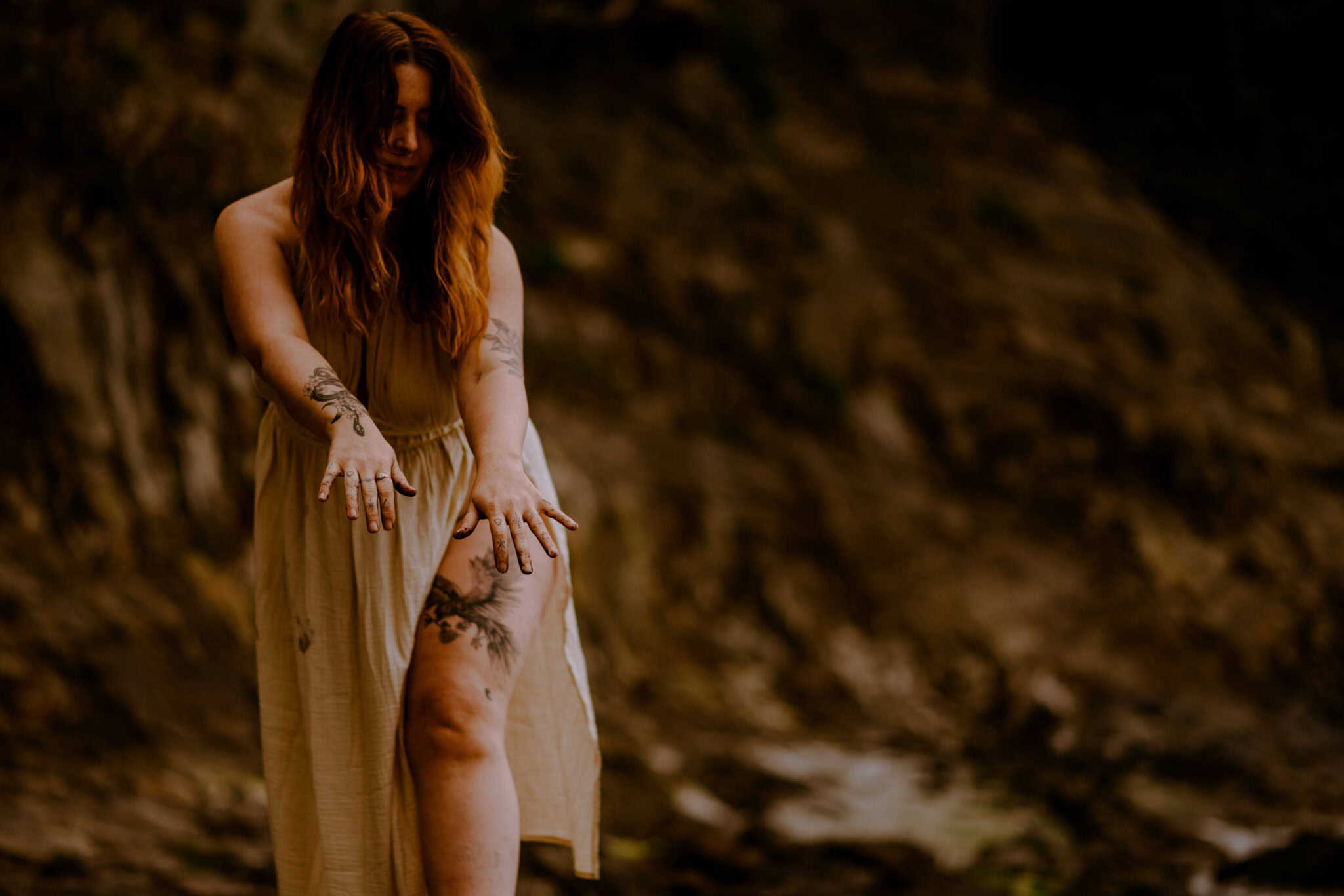 woman placing hands down as she heals the sister wound during a women's retreat