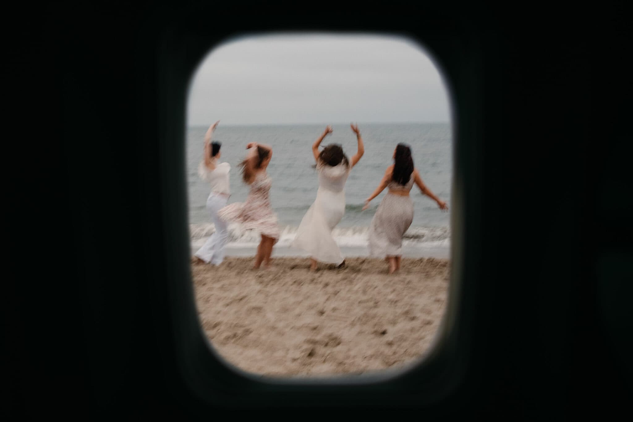 women framed dancing on a beach