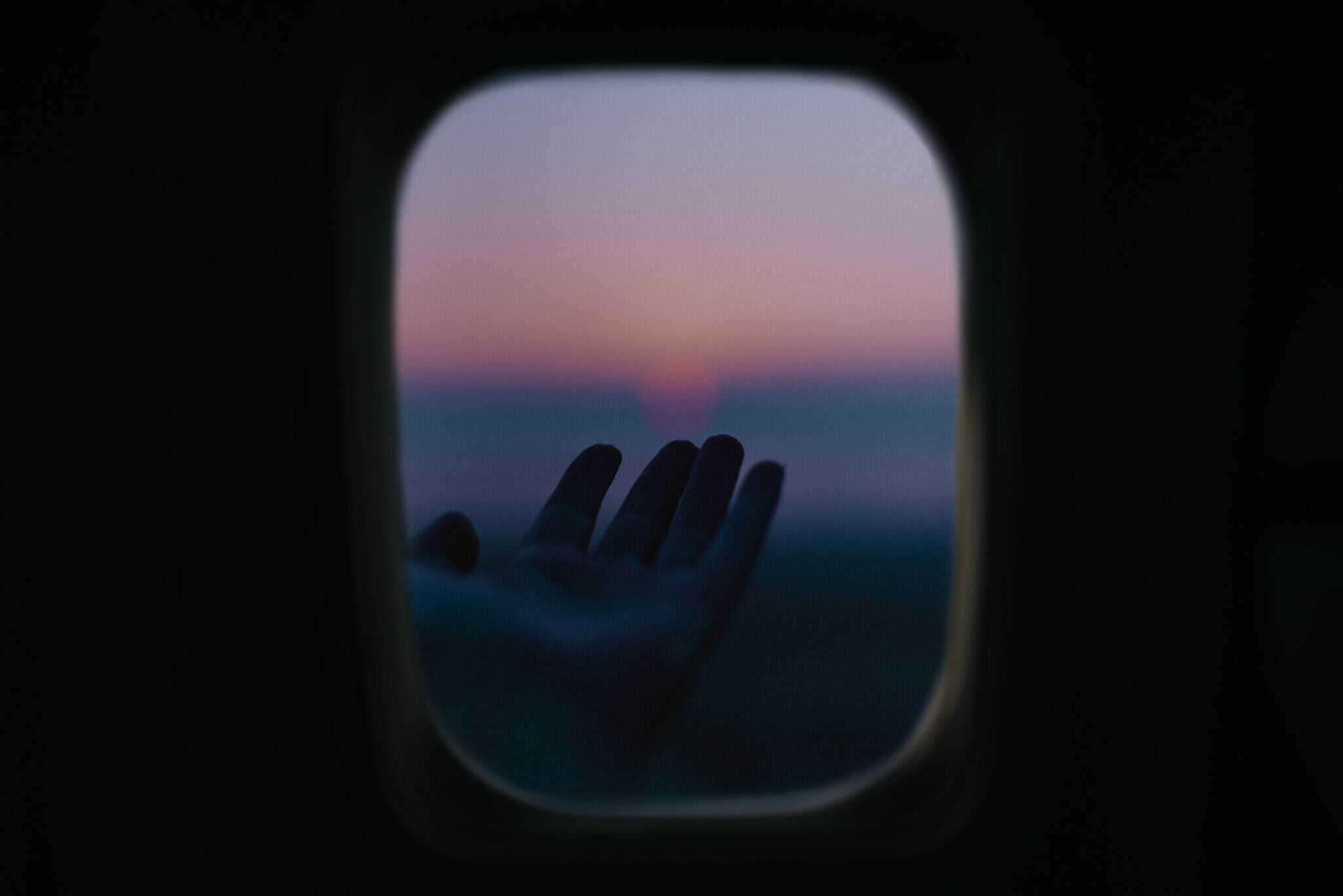 hand reaching out at sunset