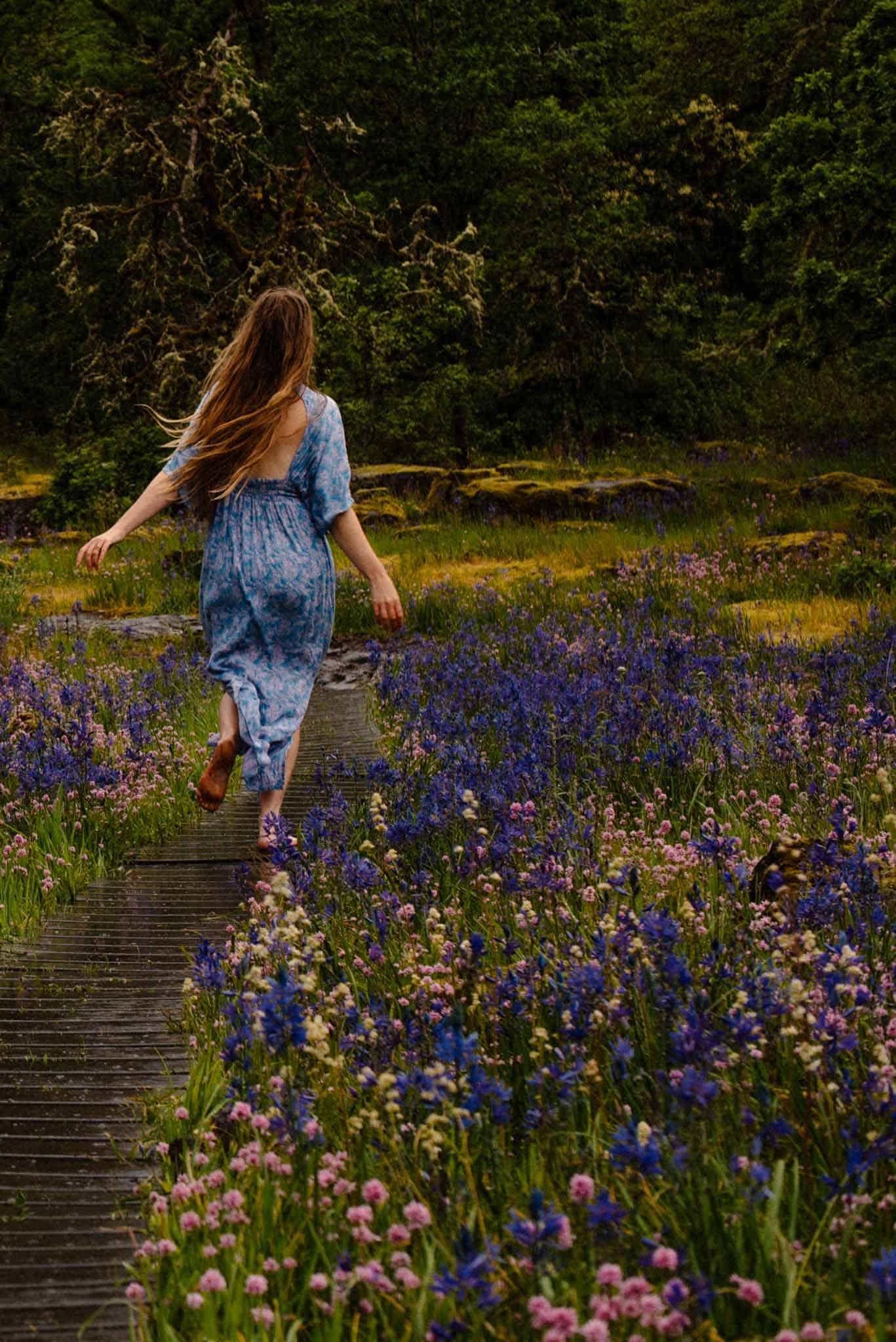 woman walking in a field of wild flowers contemplating life after self love questions and self love quiz