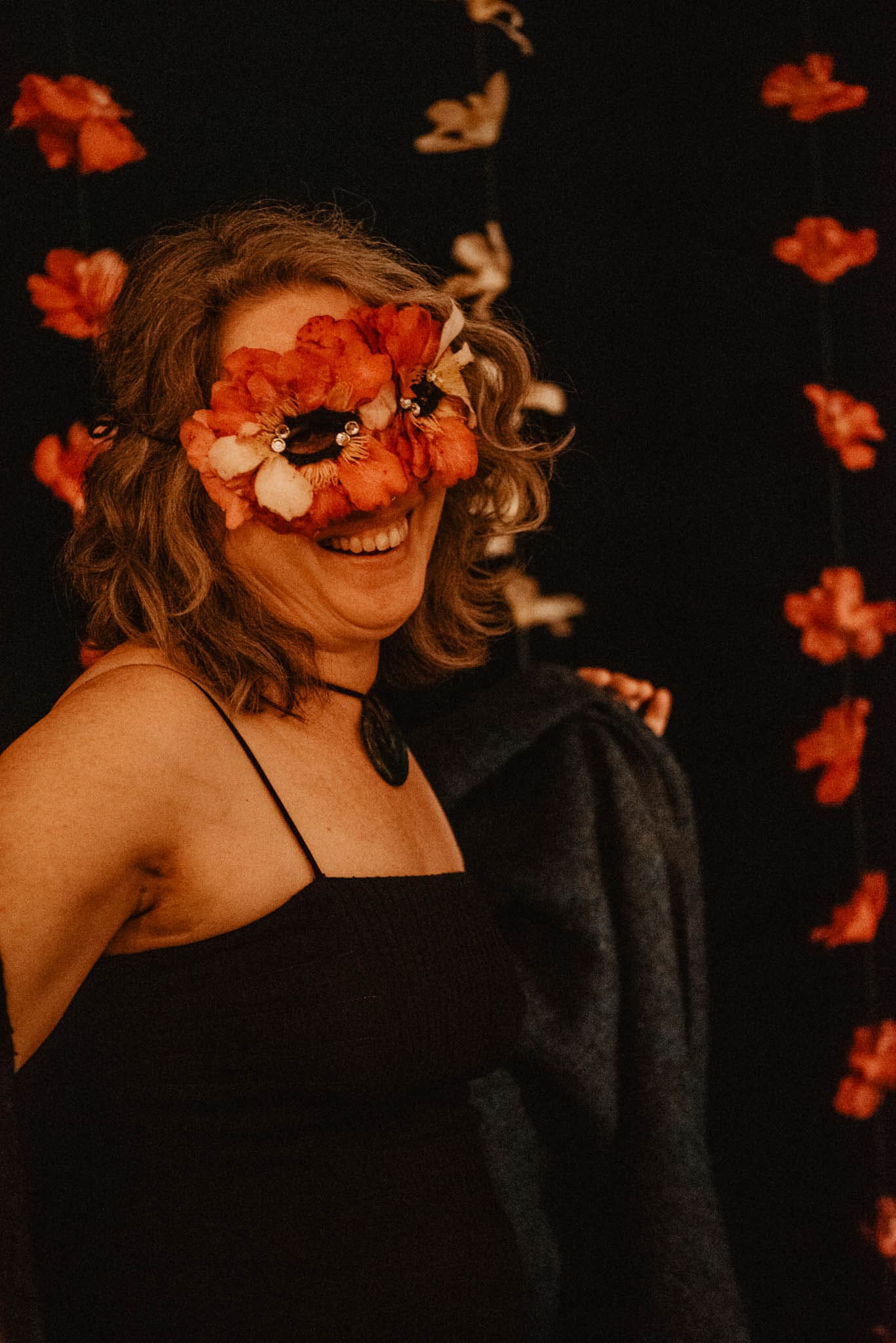 woman wearing Camellia flower mask while she dances shows the camellia flower symbolism meaning and spiritual meanings