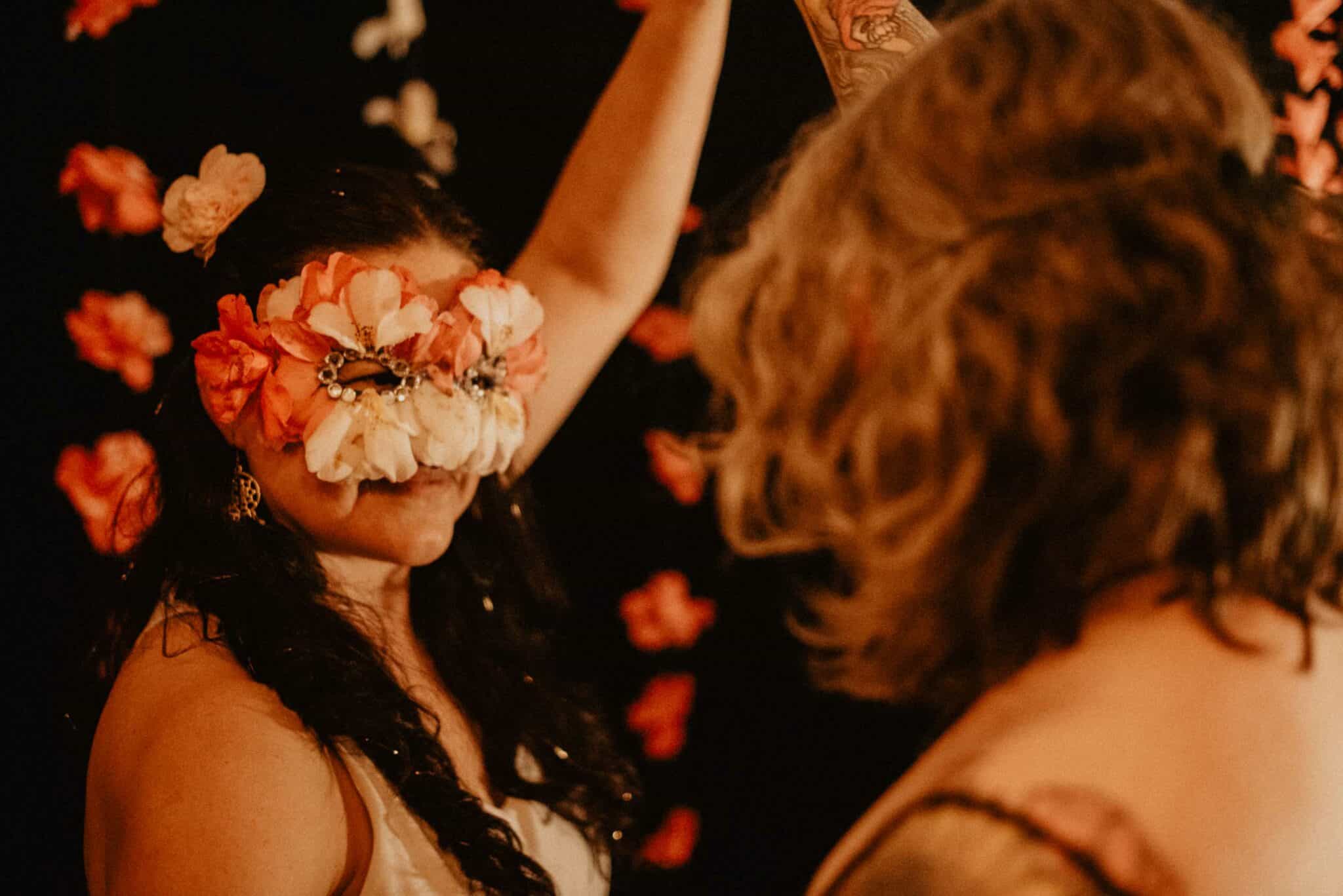 woman wearing Camellia flower mask while she dances shows the camellia flower symbolism meaning and spiritual meanings