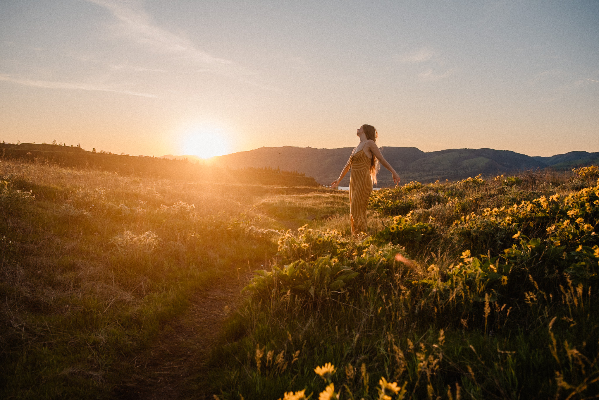 woman standing in wild flowers during a ceremony retreat of release