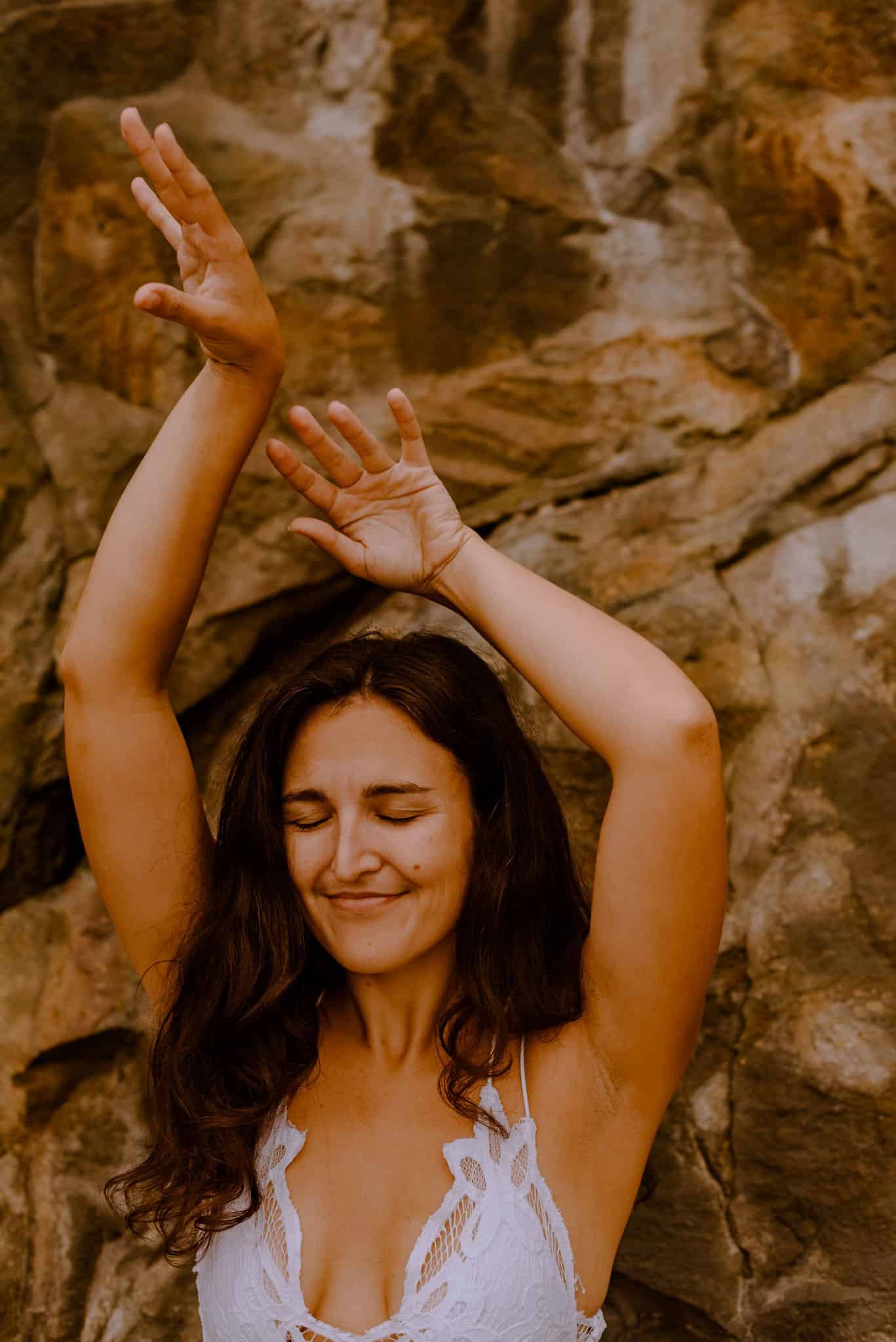 woman holding her hands up in empowermeent from how to be a siren workshop