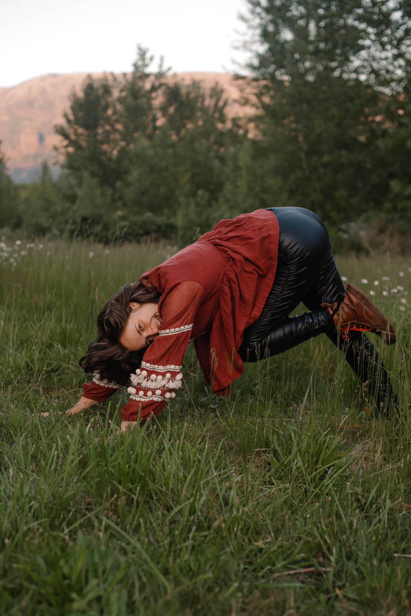 woman playing in downward dog embodied healing example feeling her feelings
