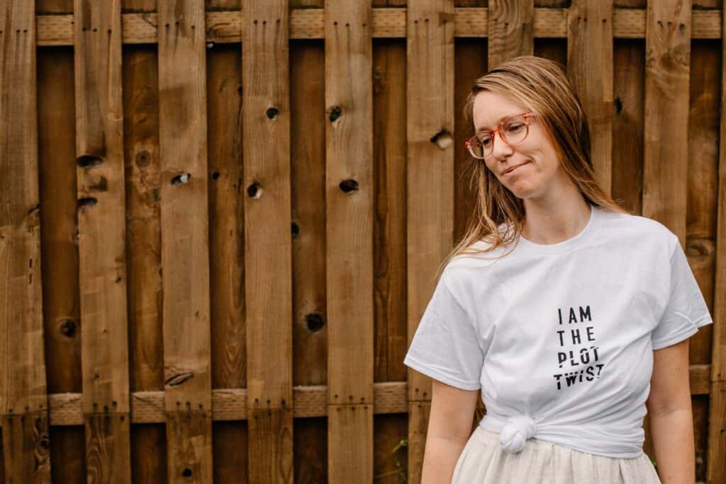"I am the plot twist" t-shirt with Lumalia wearing it with a tided bottom corner