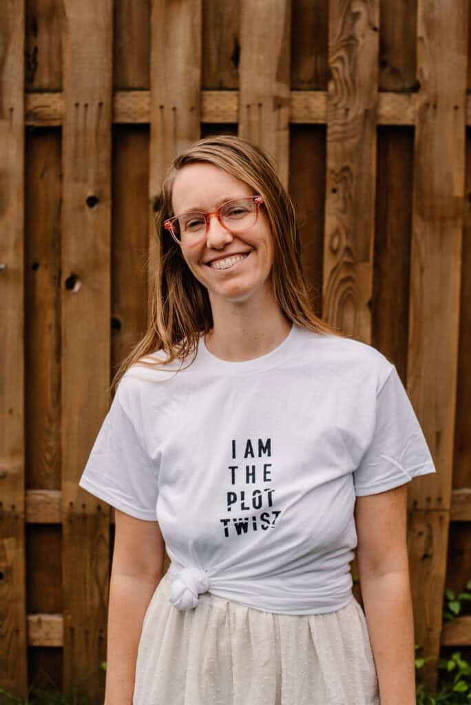 "I am the plot twist" t-shirt with Lumalia wearing it with a tided bottom corner