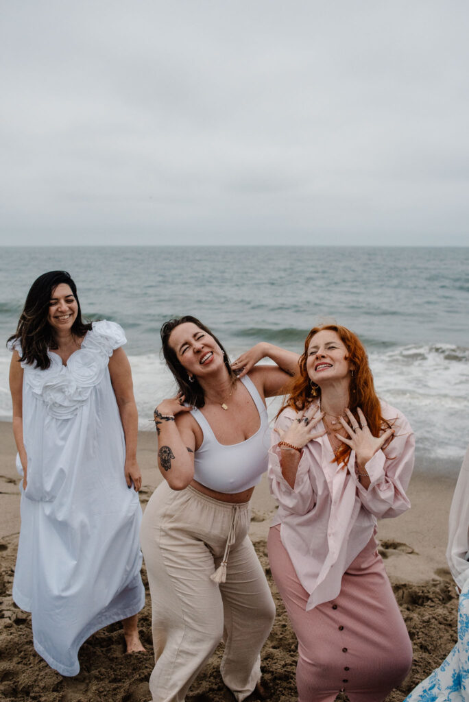 womaning fanning themselves near the ocean