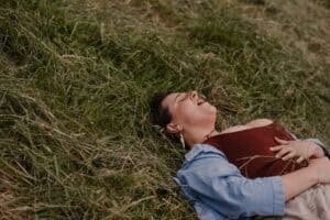 woman laying in ground releasing rage during a rage retreat using the power of the camas flower meaning during an emotional release ceremony
