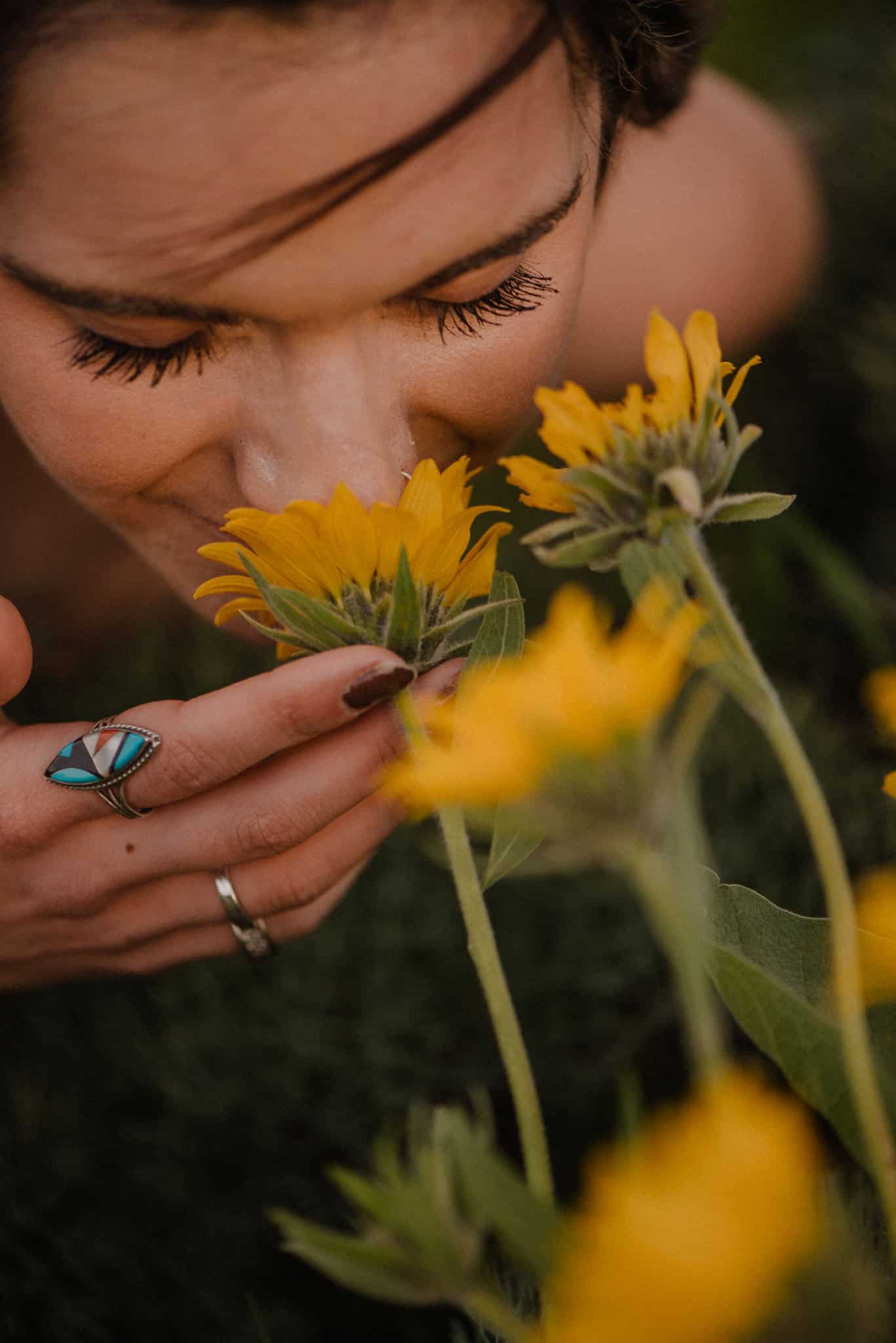 woman smelling a wild flower