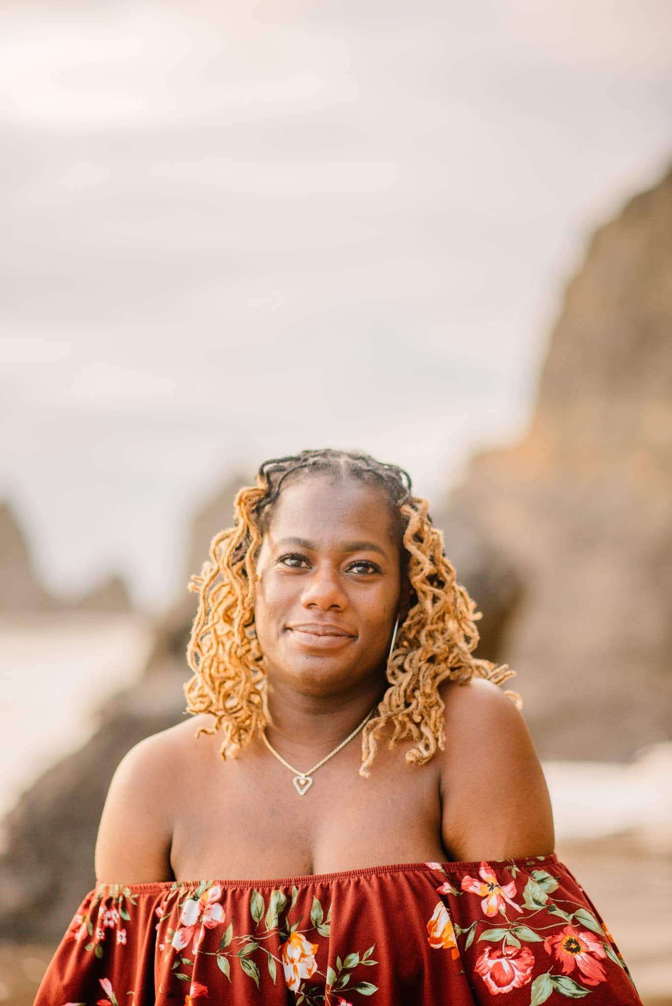 woman staring at the camera slightly smiling