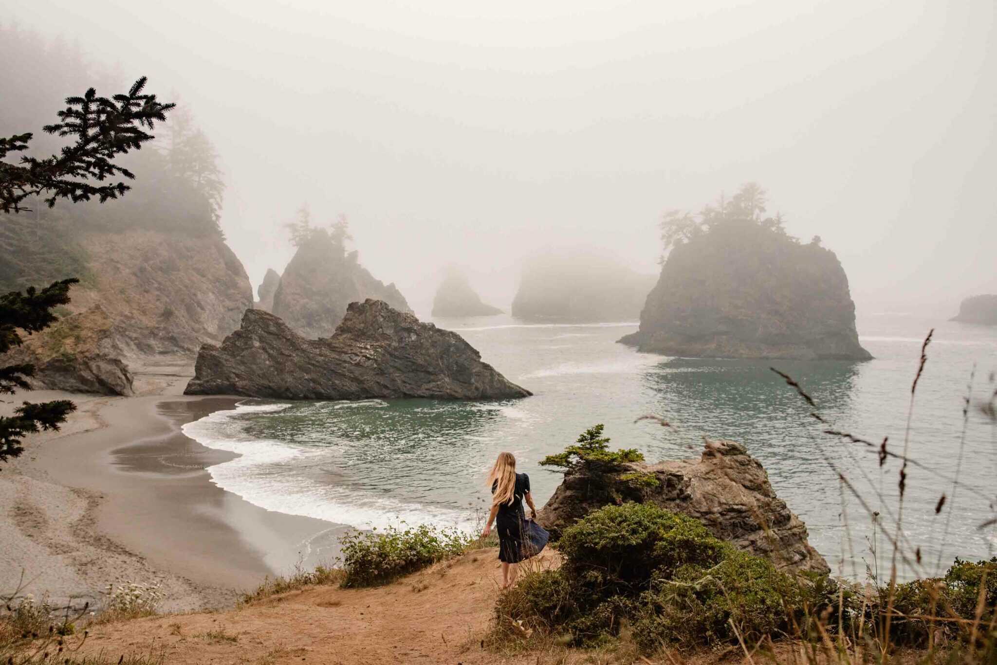 woman walking down to an ocean and sea rocks after being told she was no longer attractive