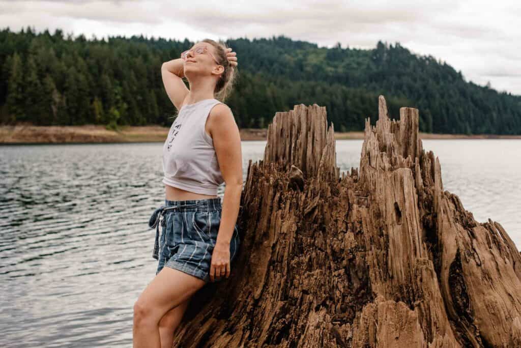 woman near a dead tree and lake telling her story about when her husbad said he was no longer attracted to her