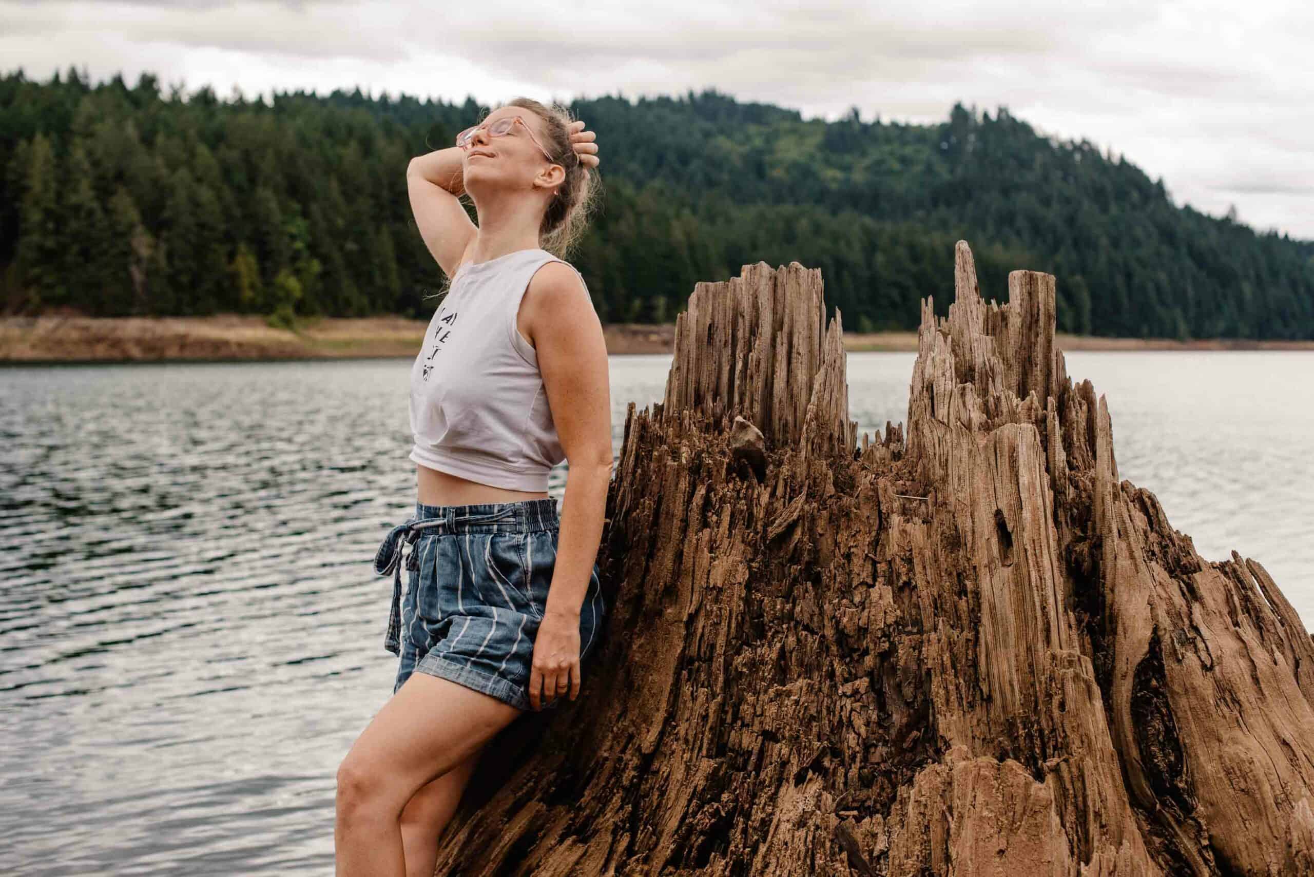 woman near a dead tree and lake telling her story about when her husbad said he was no longer attracted to her