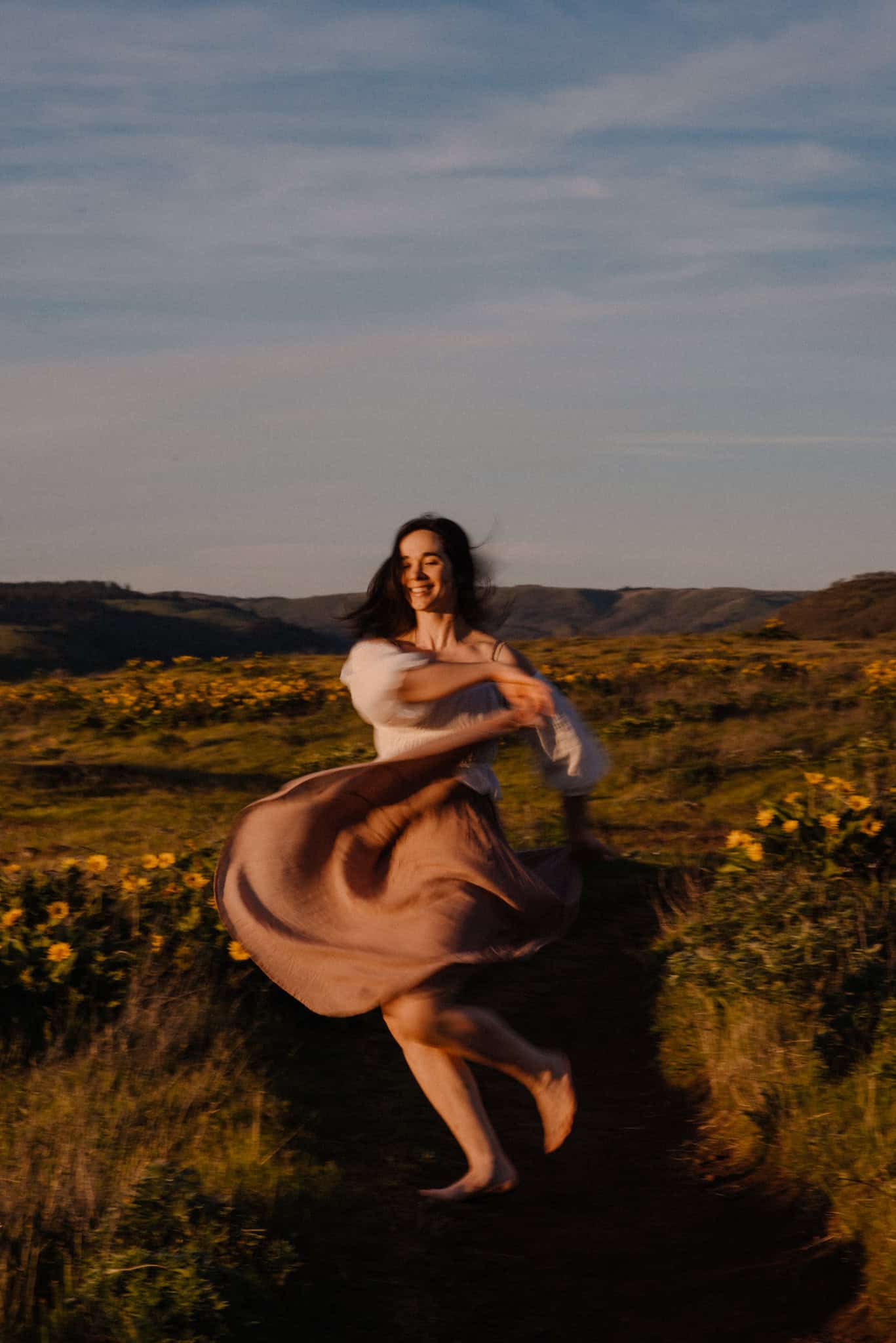 woman dancing near wild flowers