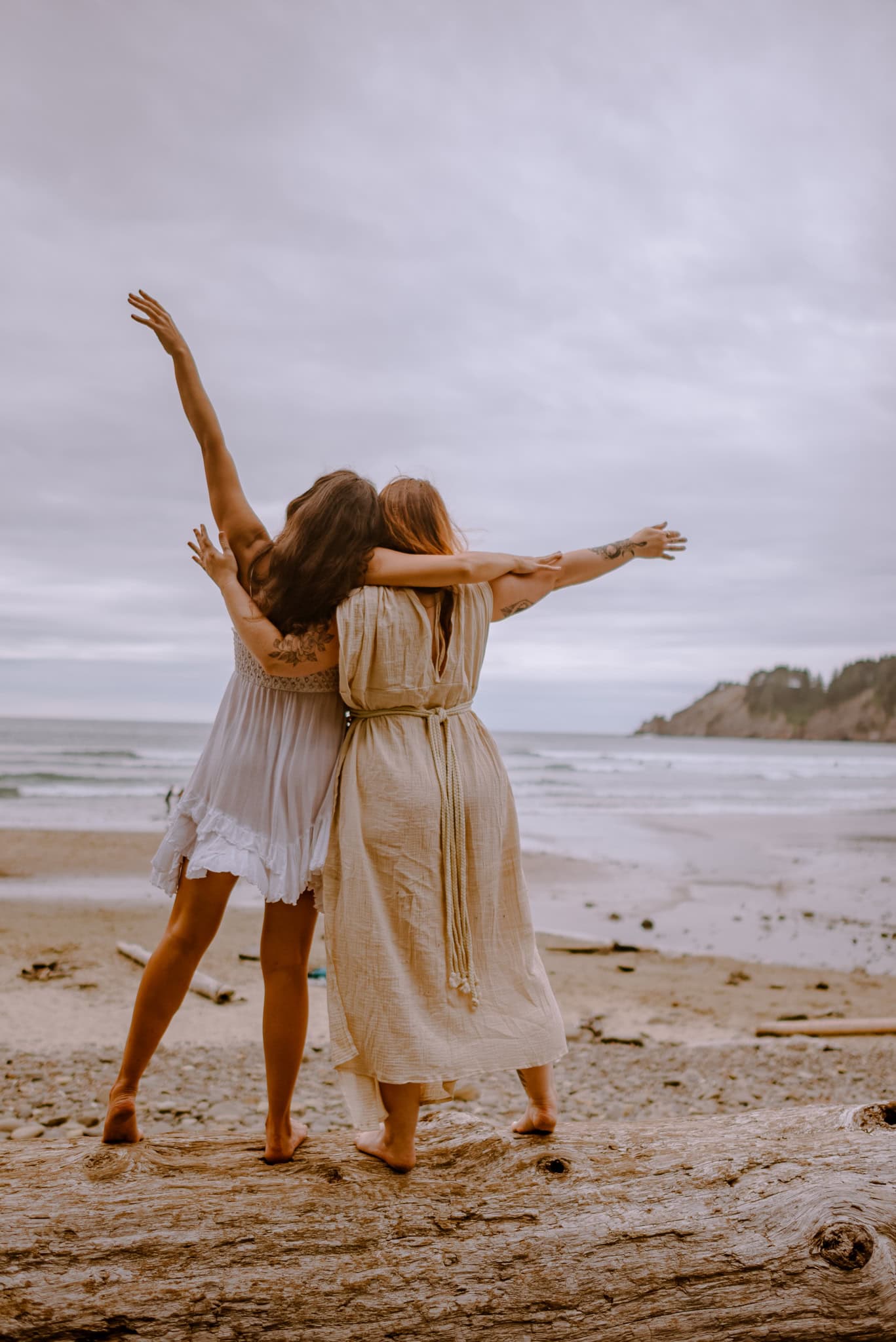 women embrancing each other near ocean