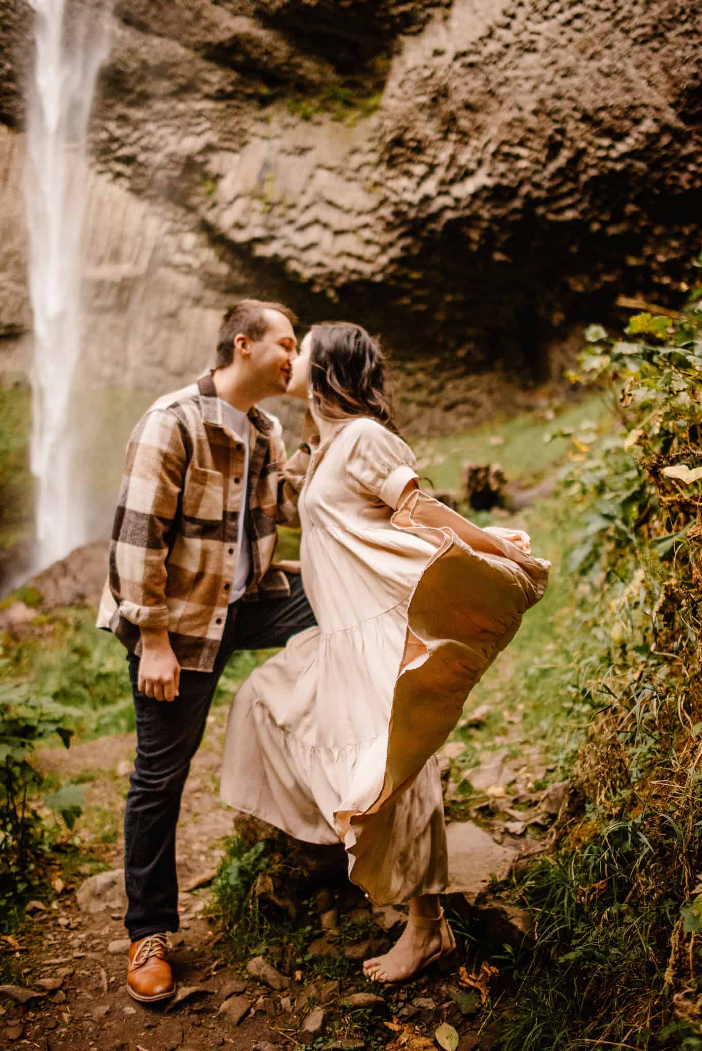couple near a waterfall during couples photography experience with Celebrate Again