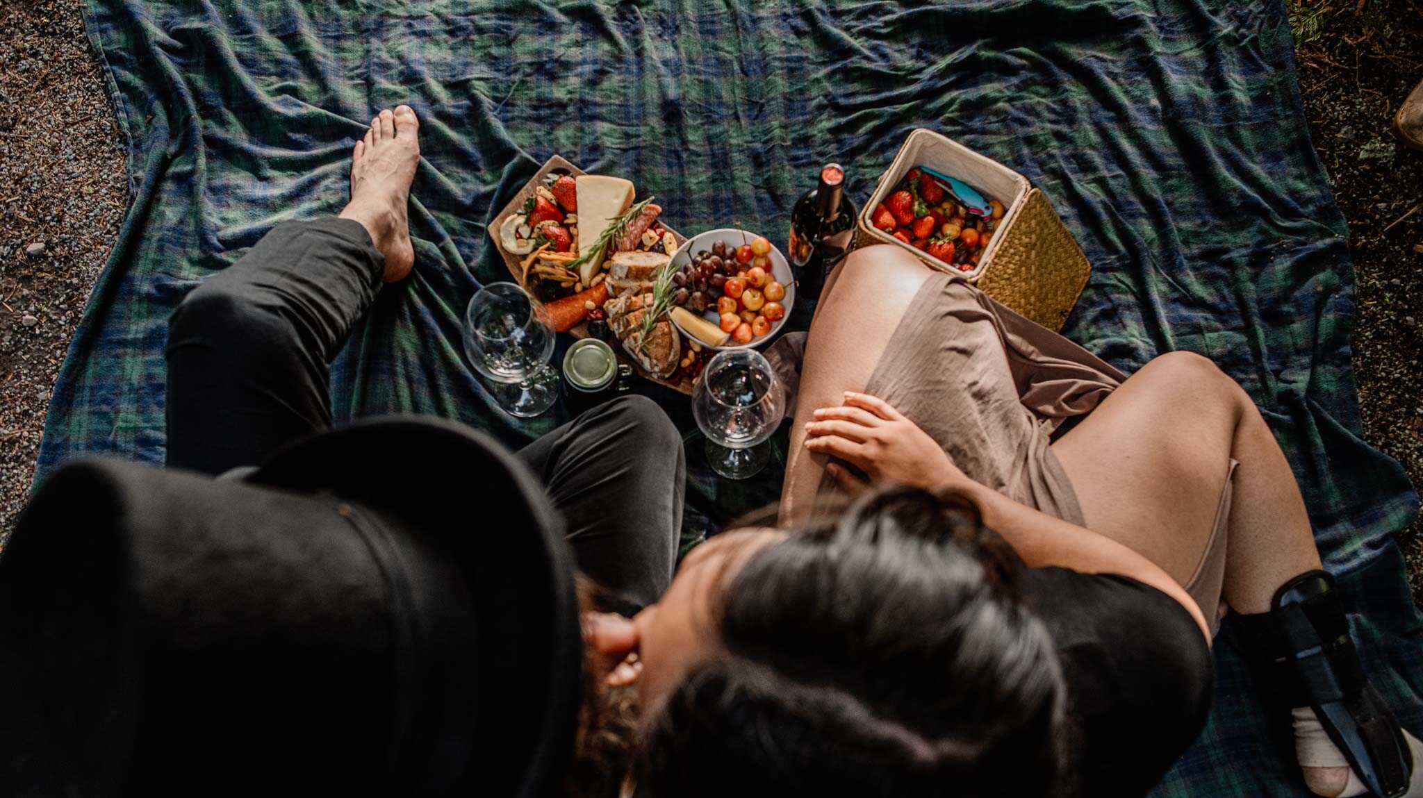 couple having a romantic picnic during engagement photos in Cathedral Park