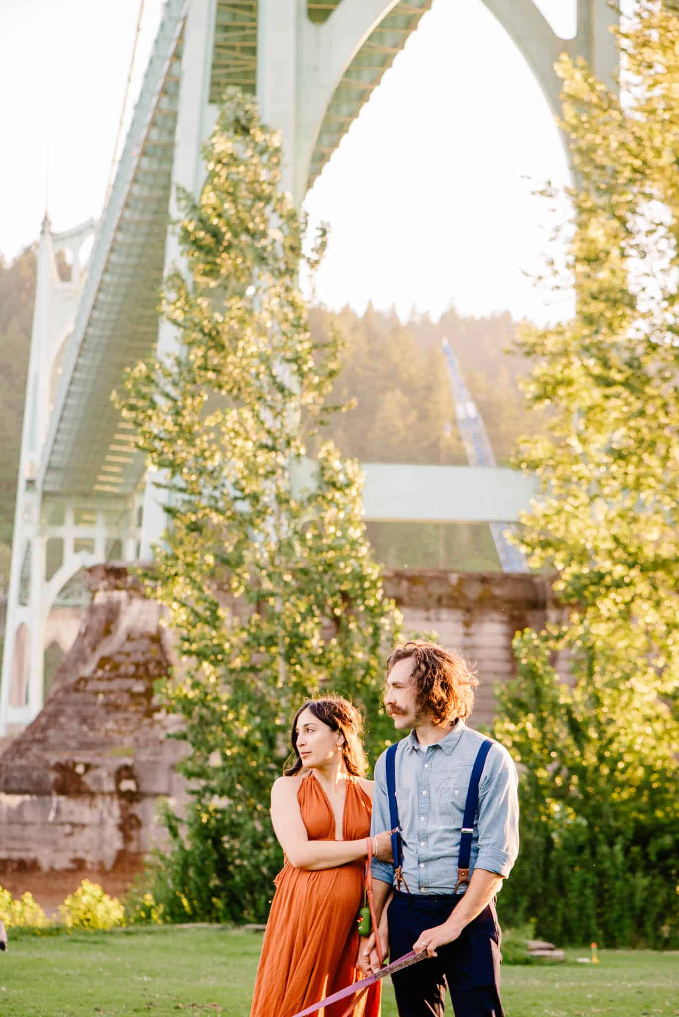 Couple in Cathedral Park snuggling close together during engagement photos in Cathedral Park