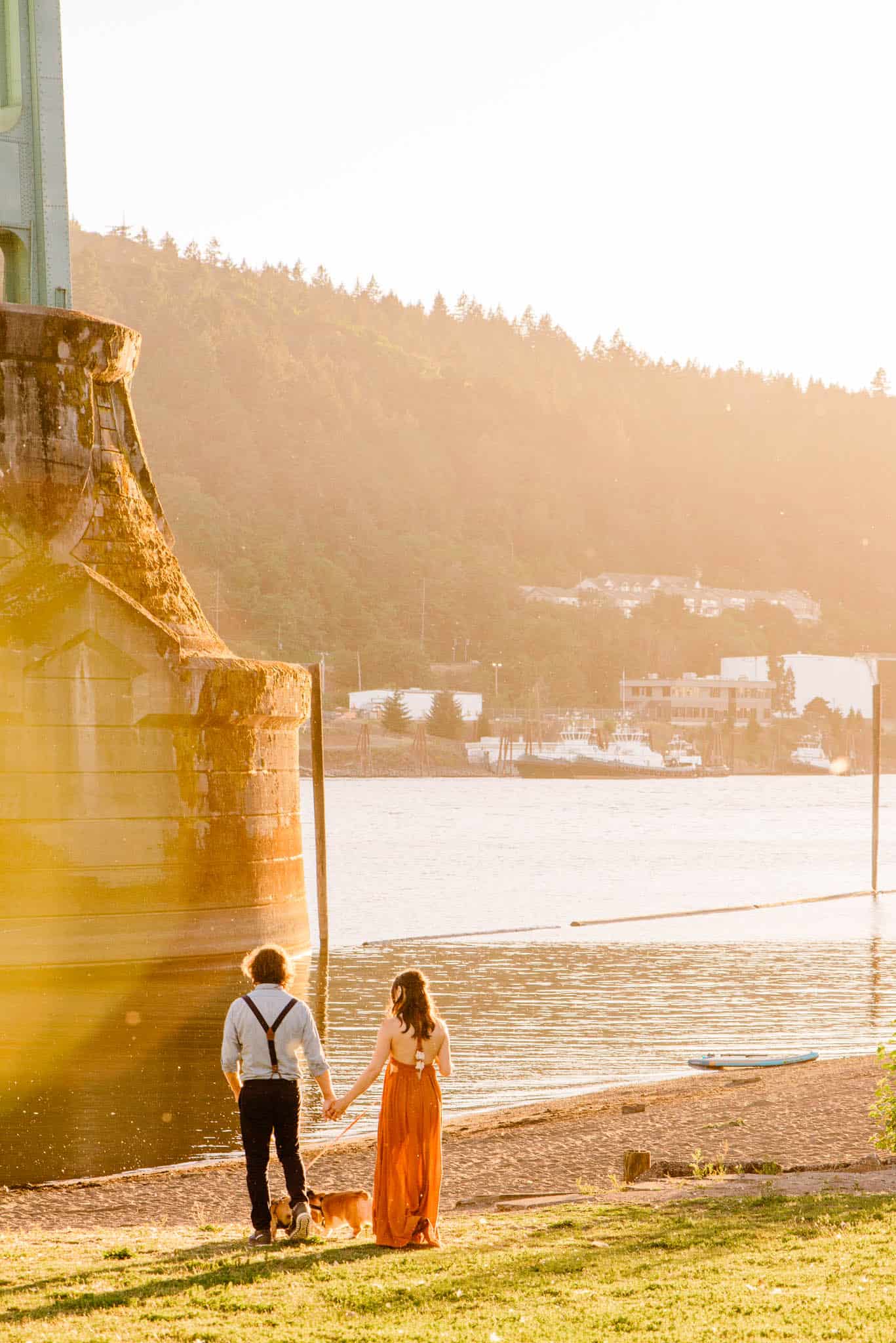 couple walking on sandy shore during engagement photos in Cathedral Park