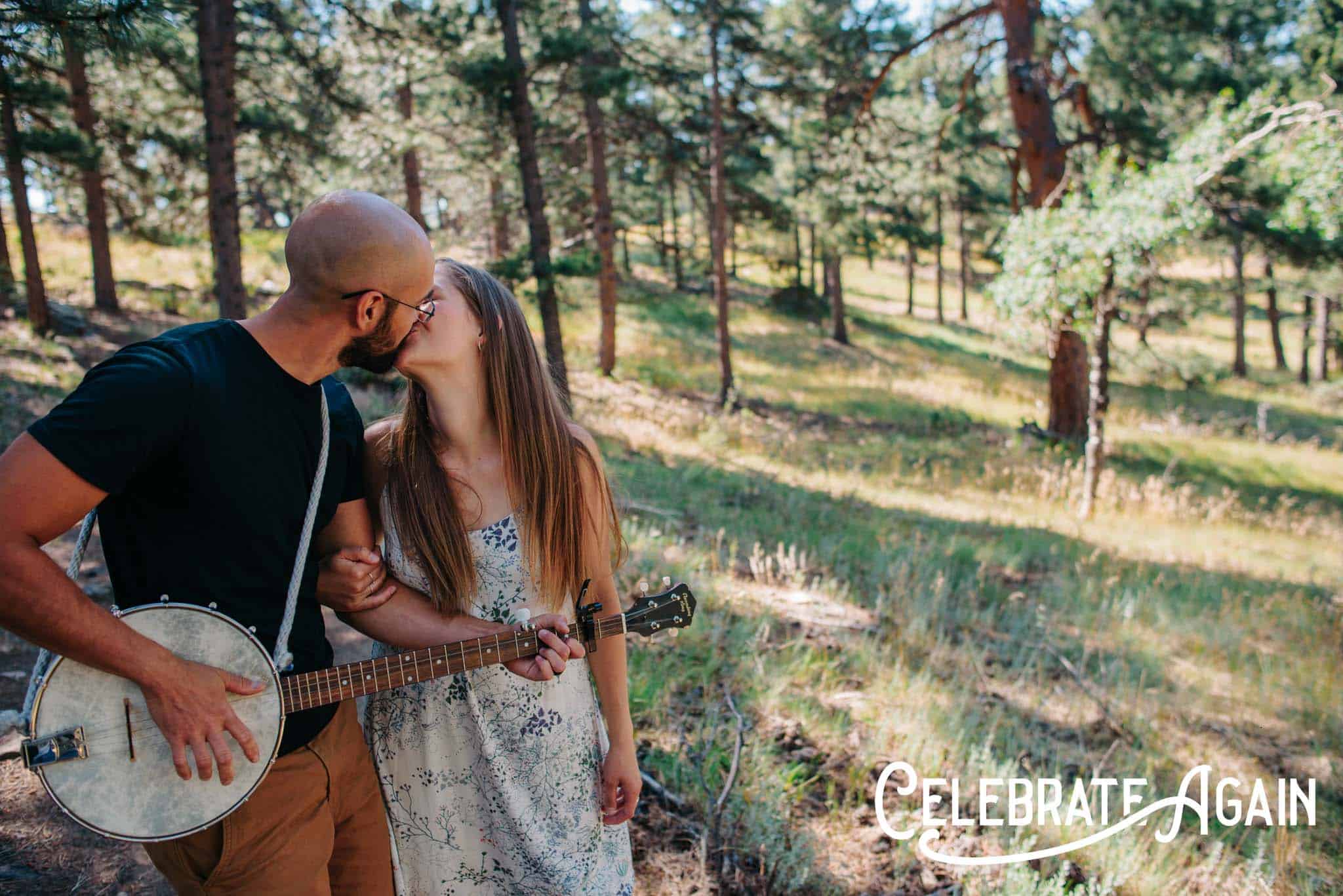 Couple kissing while one is playing the guitar at a engagement photo location in Portland, Oregon