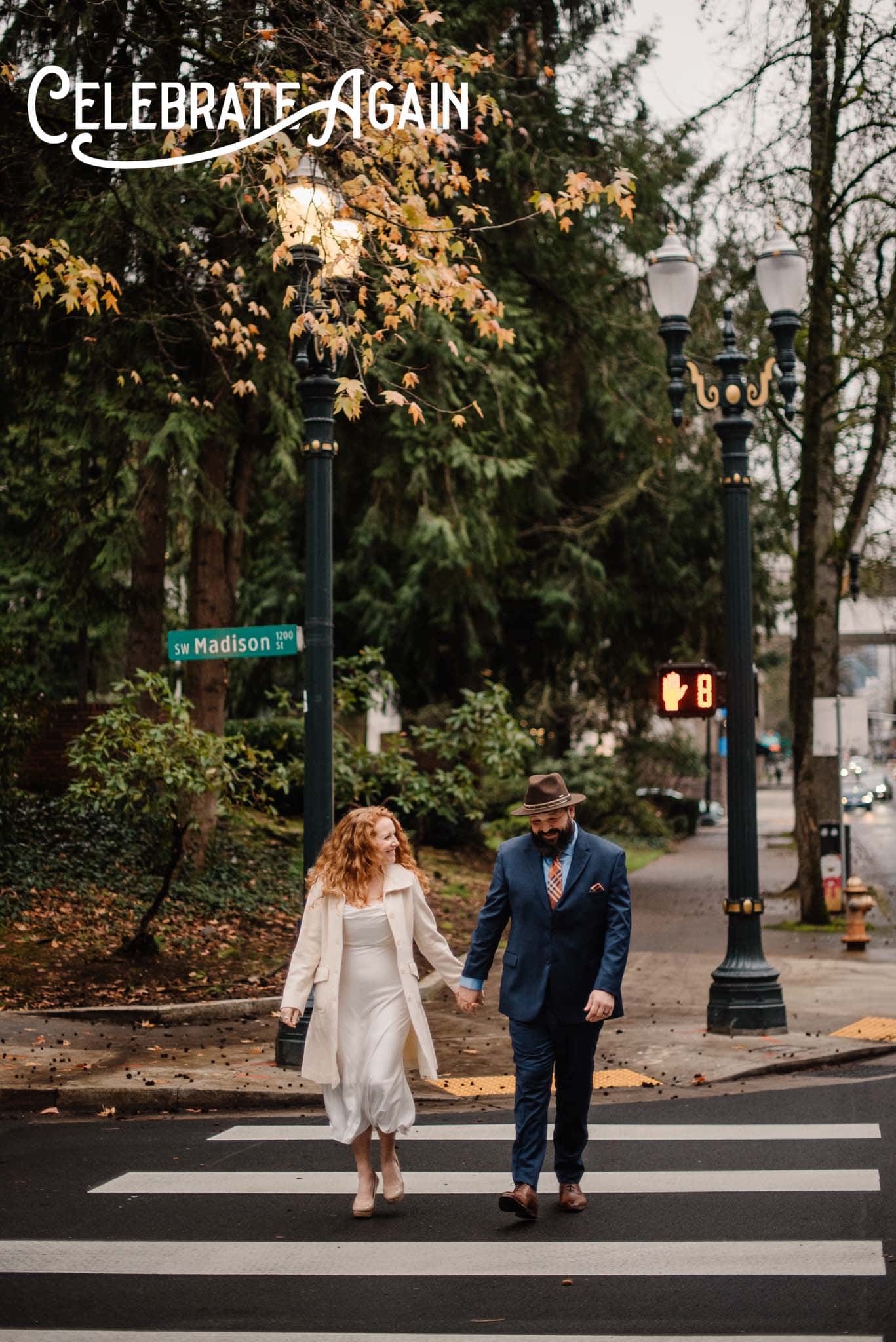 couple walking downtown crossing the street at a engagement photo location in Portland, Oregon with Celebrate Again