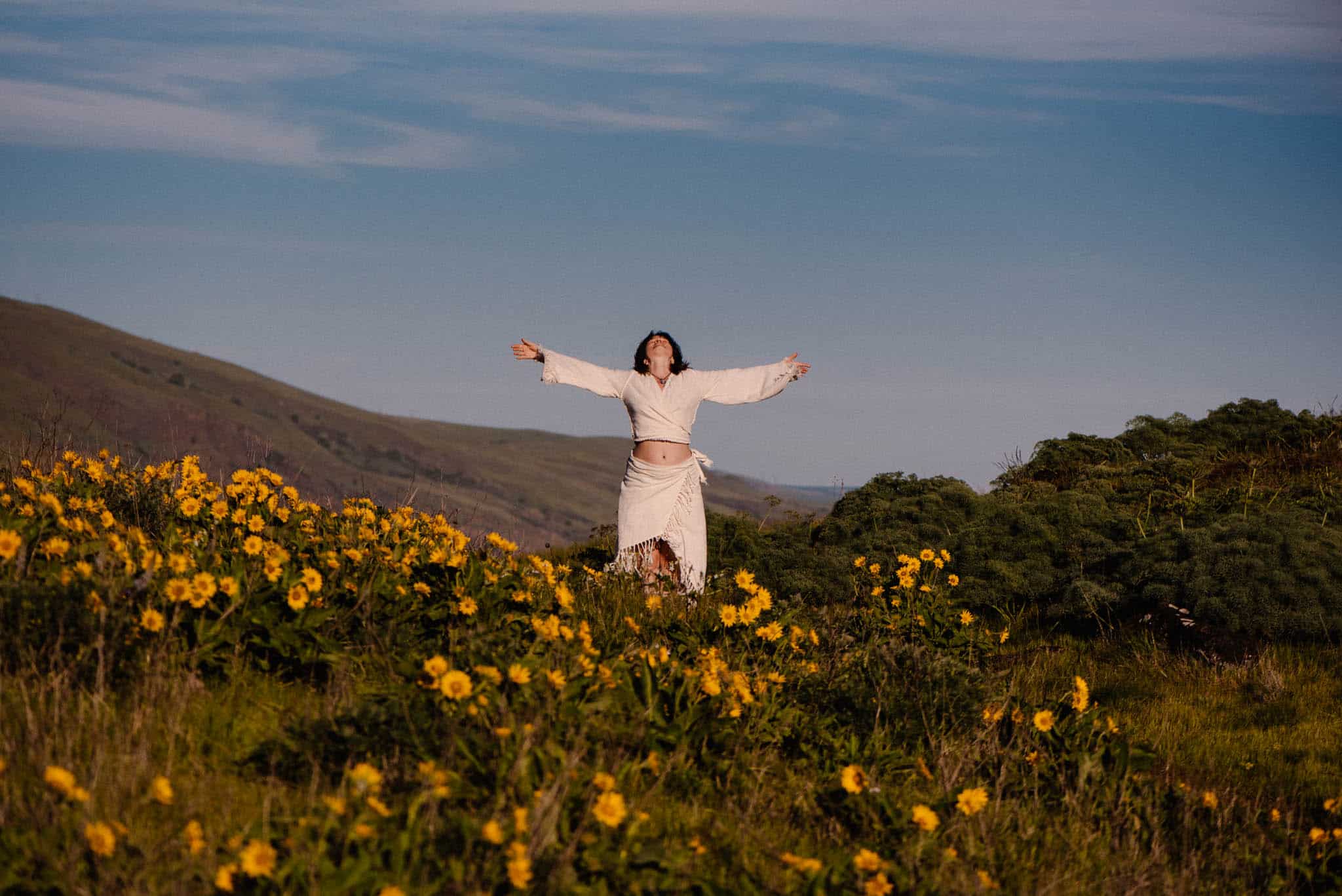 woman with arms open in an aliveness experience