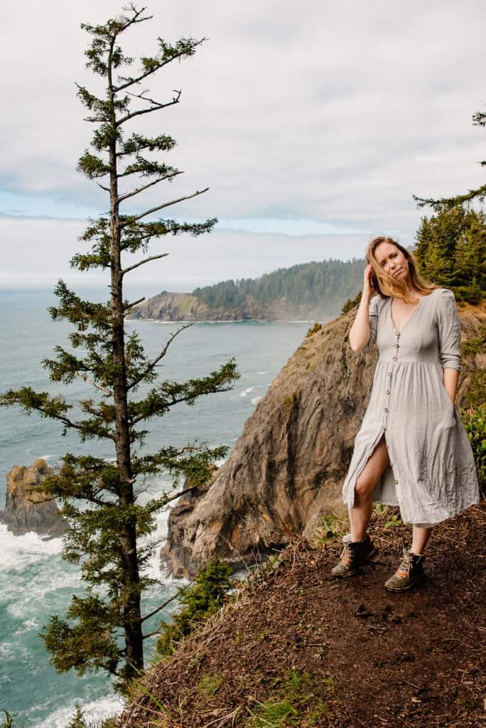 Lumalia standing on coast looking out in gray dress and reflecting on Self-Abandonment in Relationships
