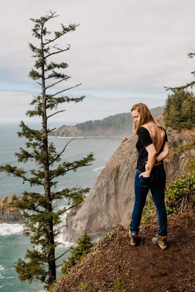 Lumalia standing on coast looking down and reflecting on Self-Abandonment in Relationships