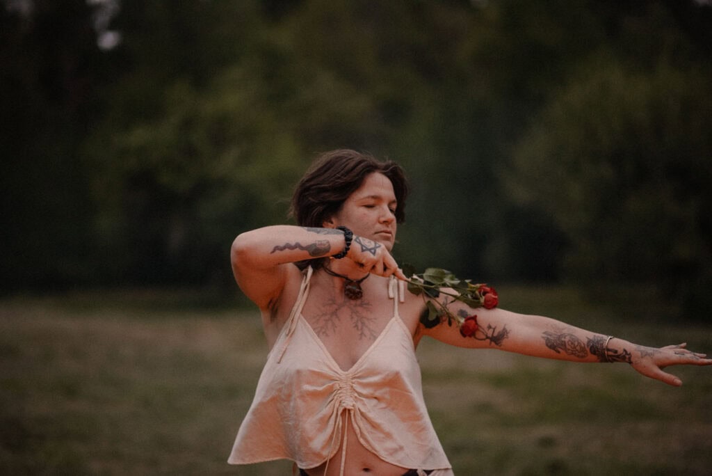 woman gliding rose over her arm during rage retreat in Oregon