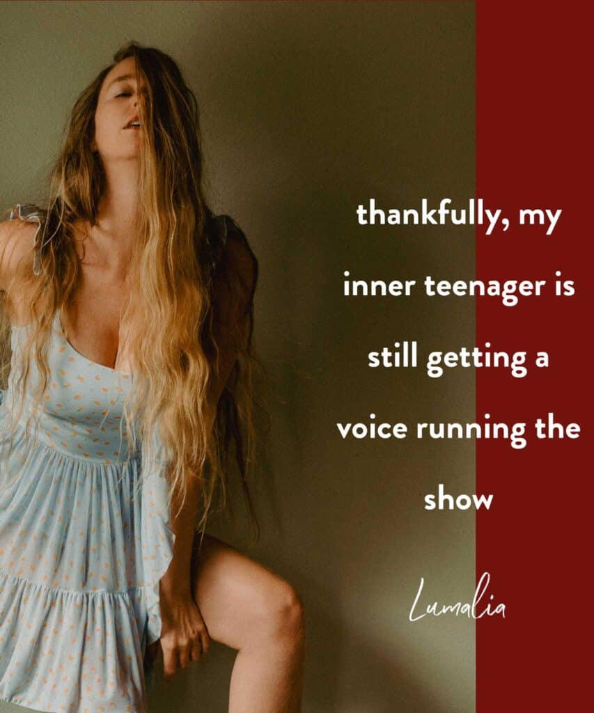 Lumalia moving through feelings of being in the messy middle of life on the floor in a self portrait dancing with text "thankfully, my inner teenager is still getting a voice running the show"