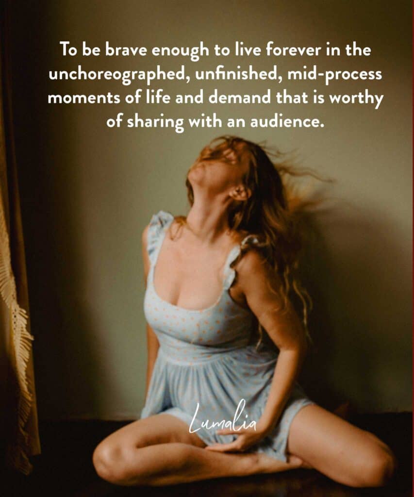 Lumalia moving through feelings of being in the messy middle of life on the floor in a self portrait dancing with text "I’m here to shift us out of a culture that celebrates only the finished and return us to celebrating the mundane magic of the middle."